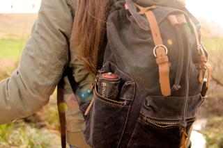 Hiker with a backpack. A Rollgut rests in the side compartment.